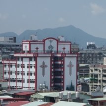 View from the building where the HESS office is located, overlooking a red and white building.