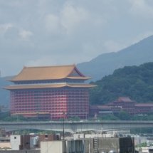 A view of a red and yellow pagoda from the building where the HESS office is.