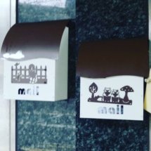Really cute little mailboxes with scenes drawn on them.